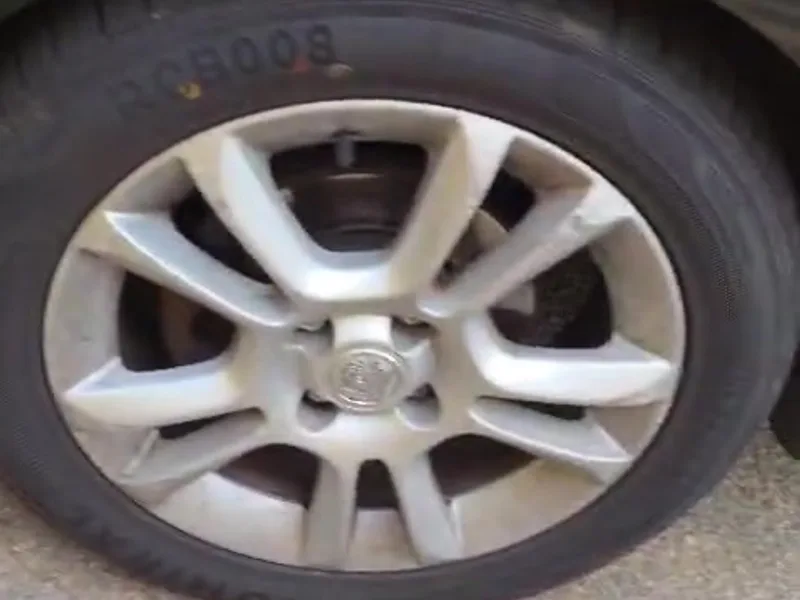 A front alloy wheel with kerbing scuffed along the outer rim.